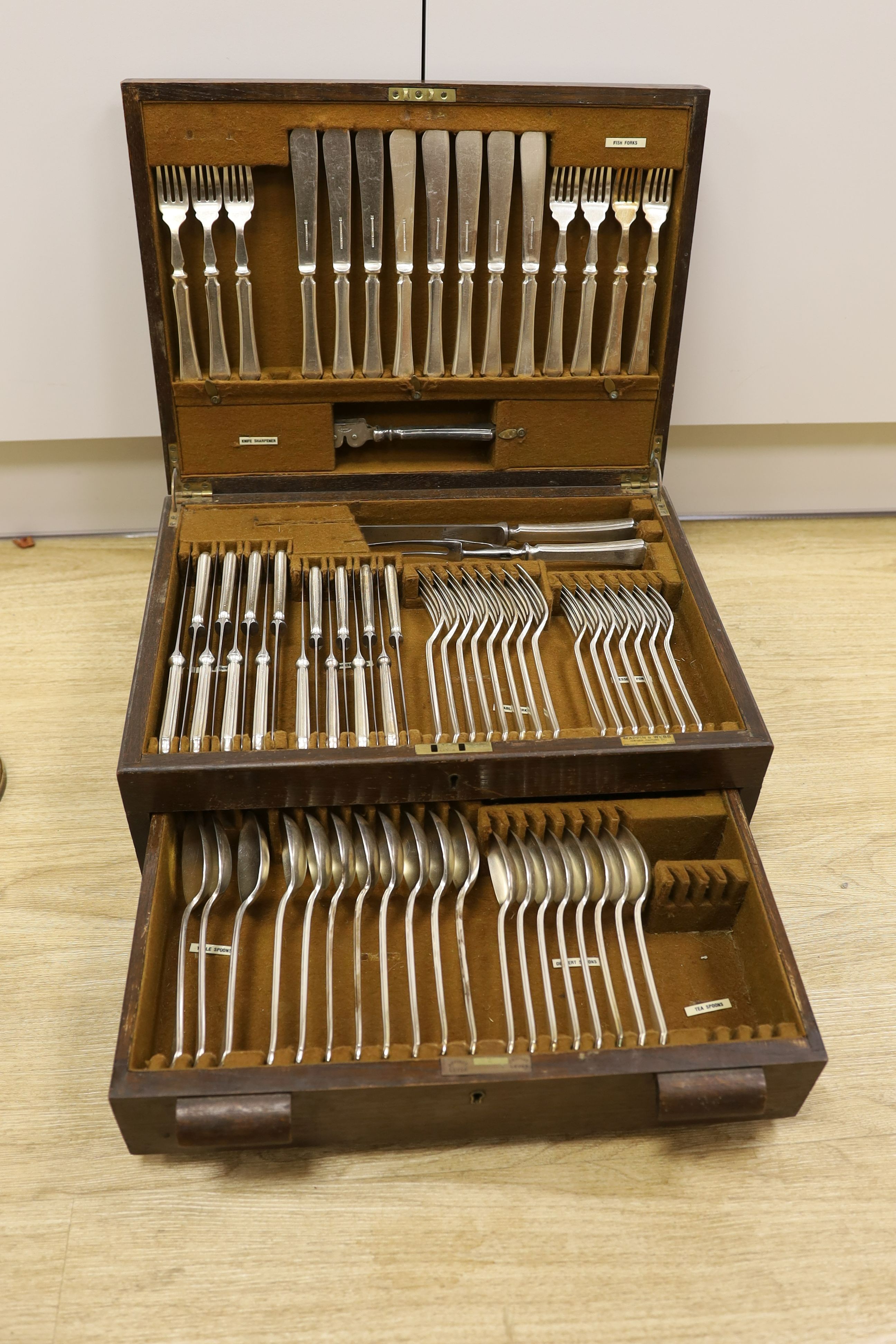 A pair of plated telescopic candlesticks and a Mappin & Webb part canteen of plated cutlery